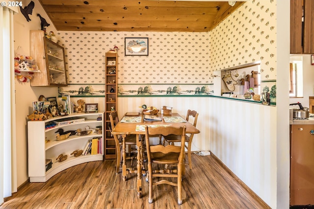 dining area featuring wood ceiling and hardwood / wood-style flooring