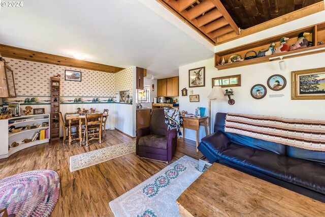 living room with beam ceiling, dark hardwood / wood-style floors, and wooden ceiling