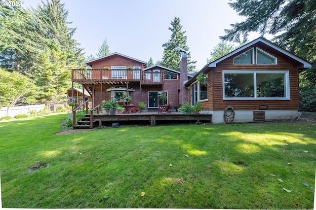 back of house with a lawn and a deck