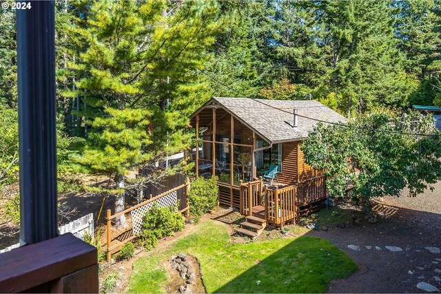 view of yard with a wooden deck and a sunroom