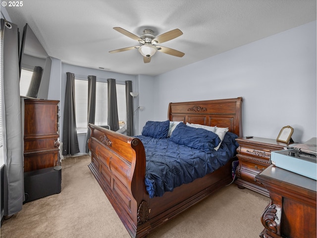 bedroom featuring a ceiling fan, visible vents, and carpet floors