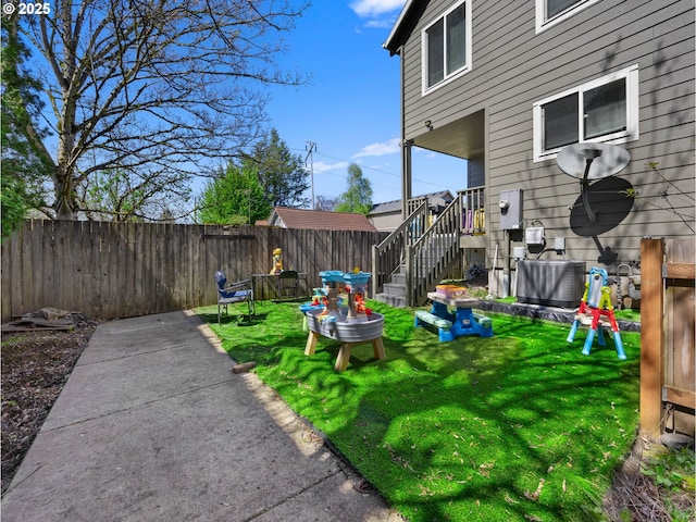 view of yard with fence and cooling unit