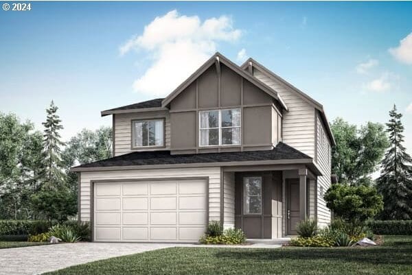 view of front of property featuring a garage and a front yard