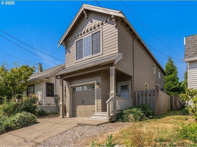 view of front of property with driveway, an attached garage, and fence