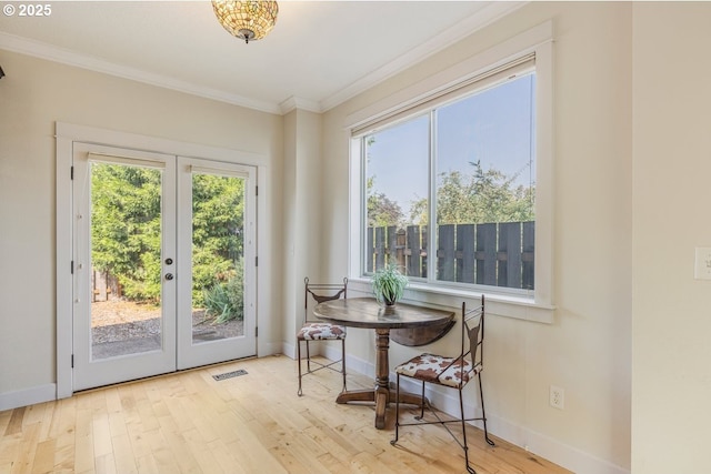 doorway to outside with crown molding, baseboards, and wood finished floors