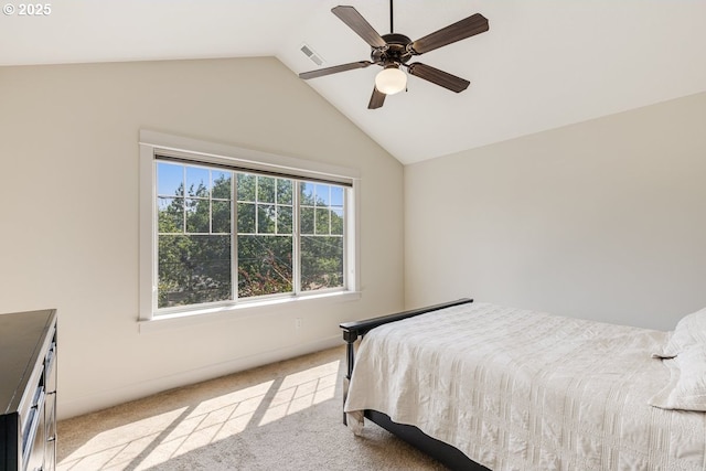 bedroom with vaulted ceiling, ceiling fan, visible vents, and light colored carpet