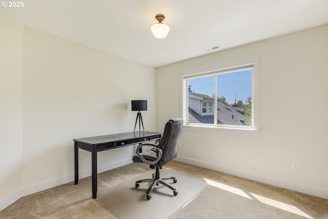 carpeted home office featuring baseboards and visible vents