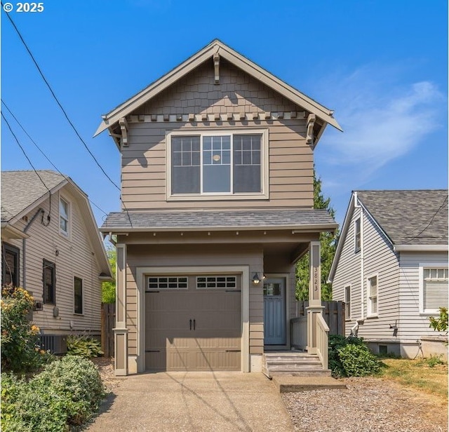 view of front of home featuring driveway, a shingled roof, and a garage