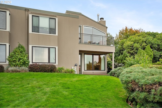 549 N Tomahawk Island Dr # 1, Portland, OR 97217 - rear view of house featuring a lawn, a chimney, and a balcony