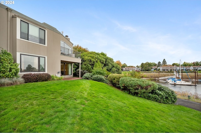 view of yard featuring a water view and a balcony