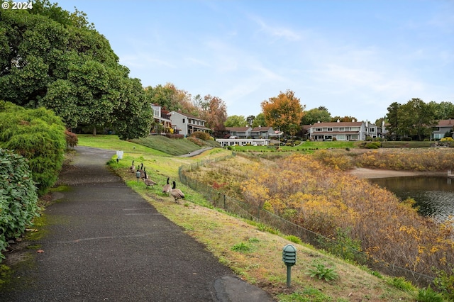 exterior space with a water view and a yard