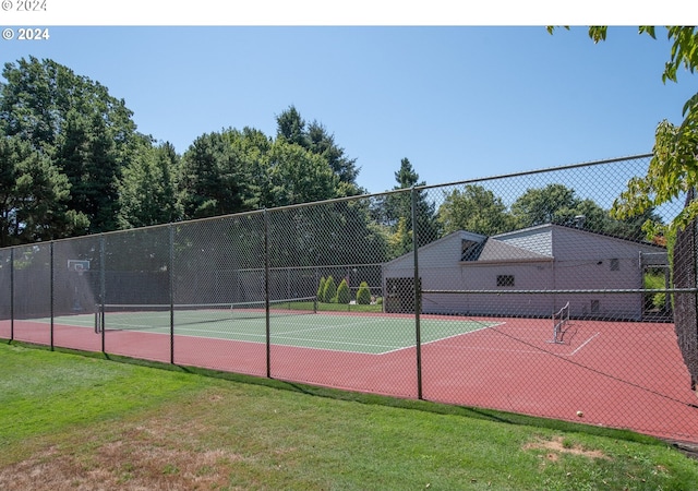 view of sport court with a lawn