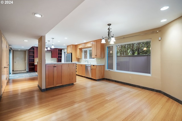 kitchen with a notable chandelier, light hardwood / wood-style flooring, hanging light fixtures, and stainless steel appliances