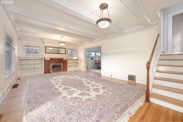 509 High St, Oregon City, OR 97045 - unfurnished living room featuring ornamental molding, beam ceiling, baseboards, wood finished floors, and stairs