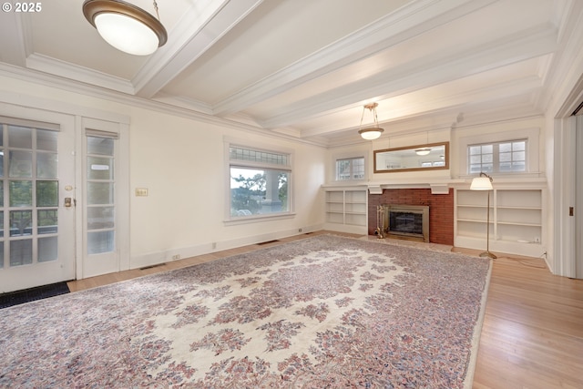 509 High St, Oregon City, OR 97045 - unfurnished living room with crown molding, wood finished floors, beamed ceiling, healthy amount of natural light, and a brick fireplace