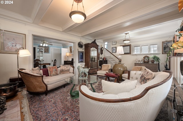 living room featuring a ceiling fan, crown molding, stairway, and beamed ceiling