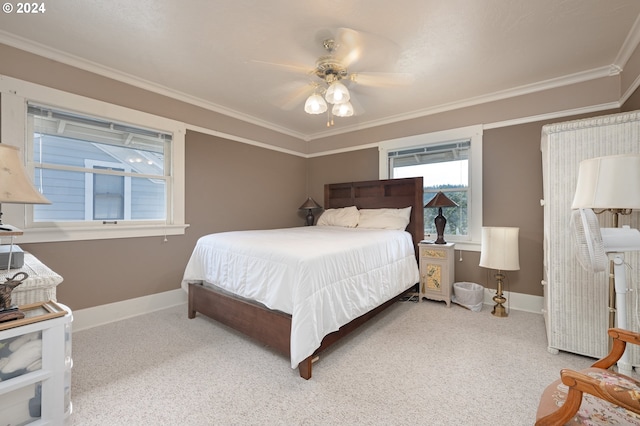 bedroom featuring light carpet, ceiling fan, baseboards, and crown molding