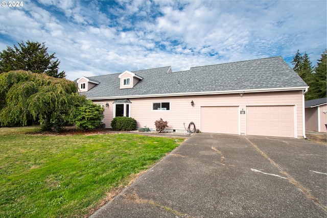 view of front of house with a front yard and a garage