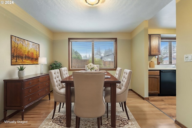 dining area with light wood-type flooring and a healthy amount of sunlight