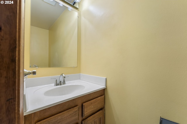 bathroom with vanity and lofted ceiling