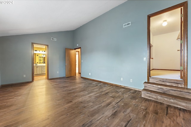 empty room featuring lofted ceiling and hardwood / wood-style flooring