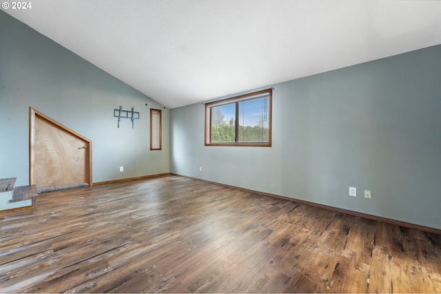 unfurnished living room with hardwood / wood-style flooring and vaulted ceiling