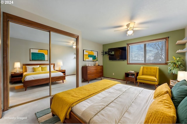 carpeted bedroom featuring ceiling fan and a closet