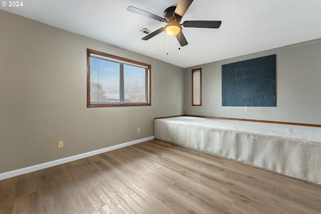 spare room featuring ceiling fan and light hardwood / wood-style floors