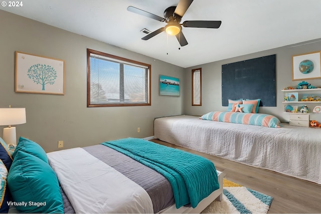 bedroom with ceiling fan and light wood-type flooring