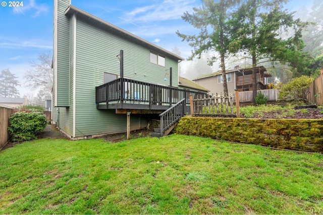 back of house with a lawn and a deck