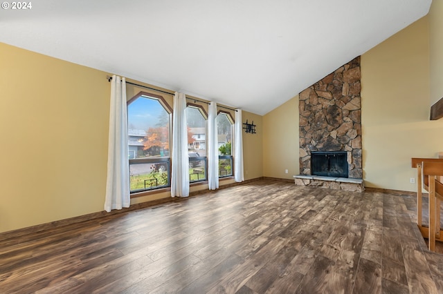 unfurnished living room with a stone fireplace, high vaulted ceiling, and dark wood-type flooring