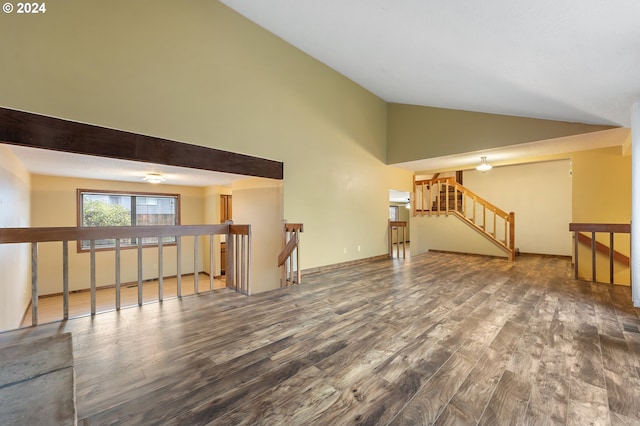 unfurnished living room featuring wood-type flooring and high vaulted ceiling