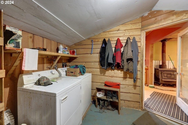 laundry area with washer and dryer and wood walls