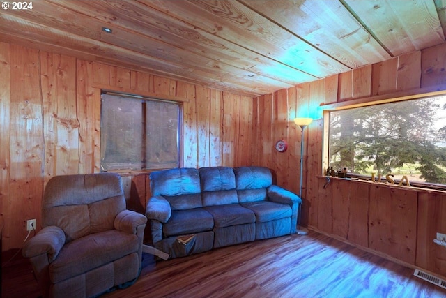 living room with wooden walls, wood ceiling, and light hardwood / wood-style flooring