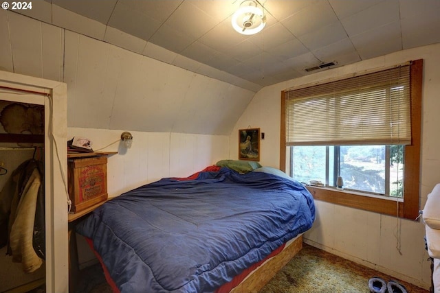 carpeted bedroom with lofted ceiling