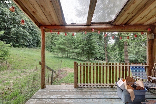 wooden terrace featuring a yard