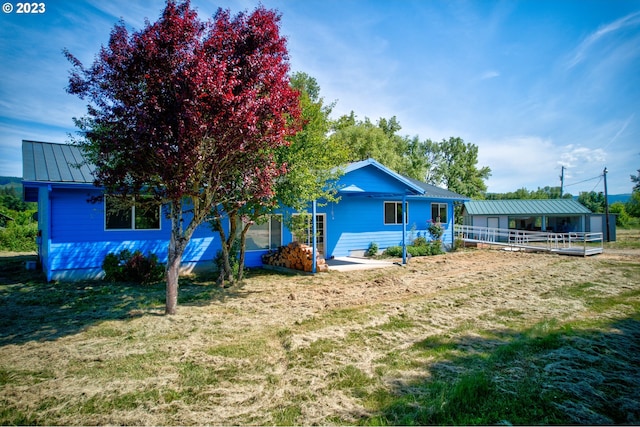 rear view of house featuring a yard