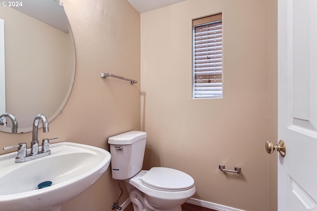 bathroom featuring sink and toilet