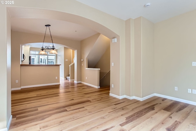 interior space with light hardwood / wood-style floors and a chandelier