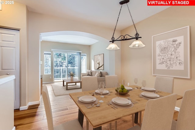 dining space with wood-type flooring