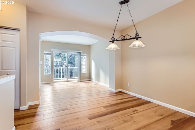 unfurnished dining area featuring wood-type flooring