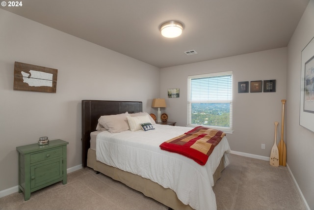 bedroom featuring light carpet, visible vents, and baseboards