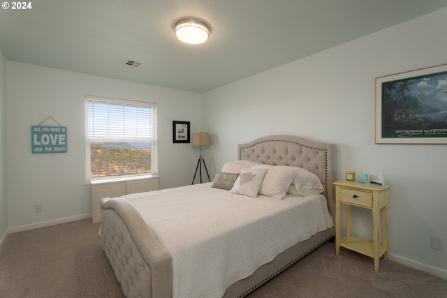 bedroom featuring carpet floors, visible vents, and baseboards