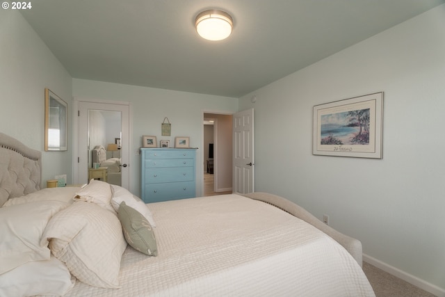 bedroom with carpet and baseboards