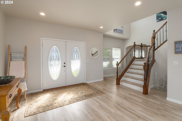 entryway featuring stairs, french doors, light wood-type flooring, and recessed lighting