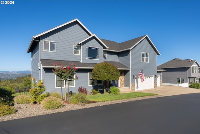 traditional-style home featuring a garage and driveway