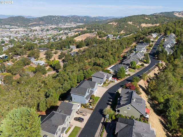 drone / aerial view featuring a residential view and a mountain view