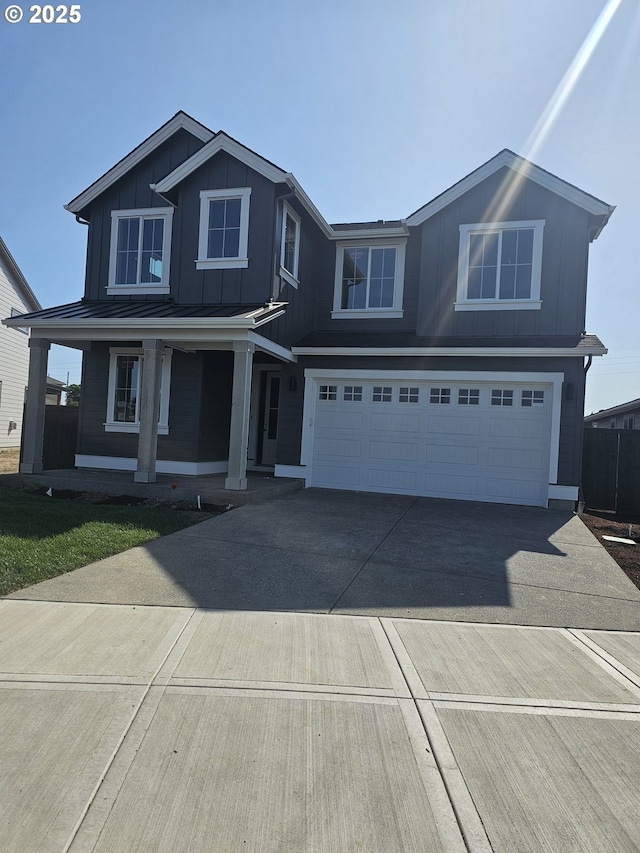3825 S Arwana Ln, Ridgefield, WA 98642 - view of front of house with a garage, concrete driveway, a porch, and board and batten siding