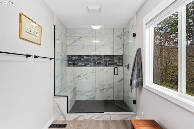 bathroom featuring wood-type flooring and an enclosed shower