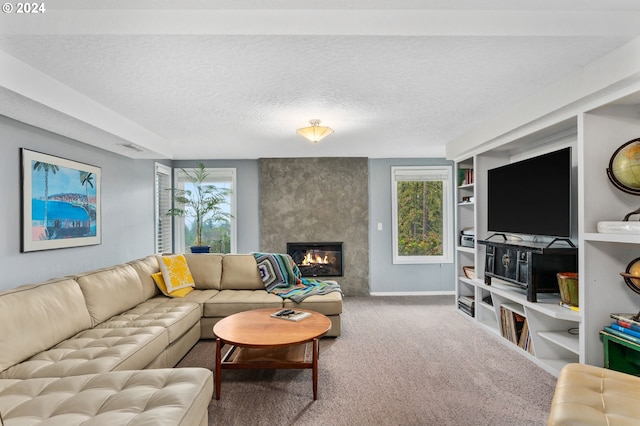 carpeted living room featuring a textured ceiling and a fireplace